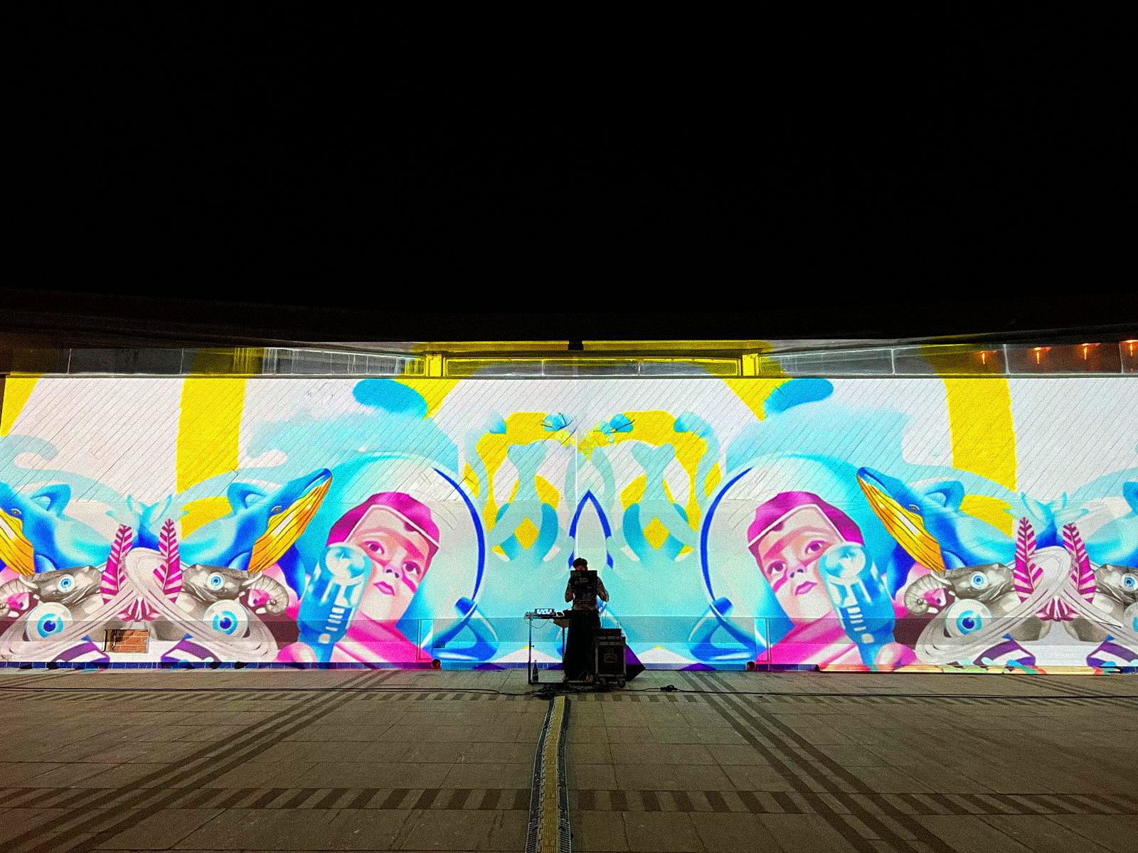FANTASTIK - whales and hand-drawn figures on the lit wall